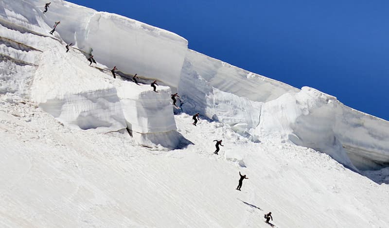 Beartooth Basin in USA - a group of people skiing down a snow covered mountain.